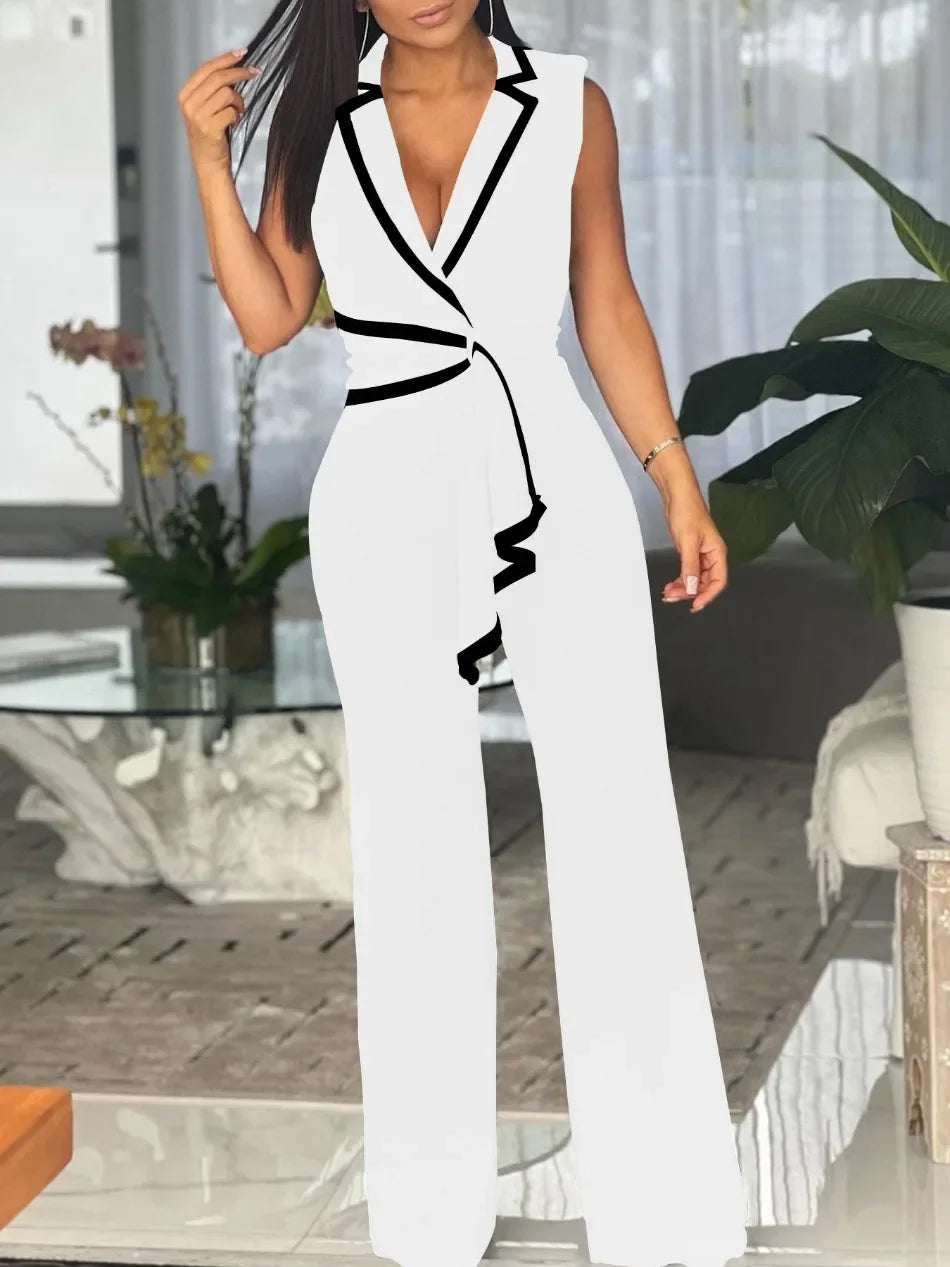 Woman wearing a white and black jumpsuit in an indoor setting.