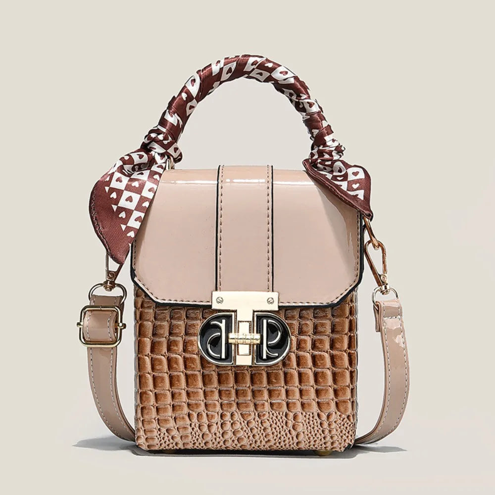 Designer handbag with patterned handle on a beige background