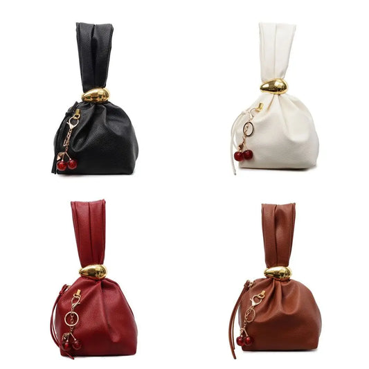 Four drawstring bags in black, white, red, and brown with decorative elements on a white background.