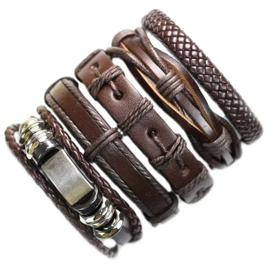 Set of brown leather bracelets with metal accents on a white background