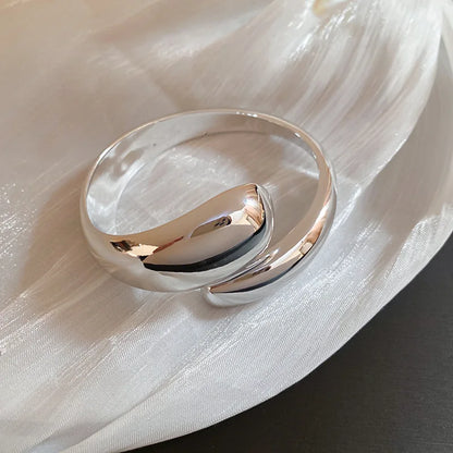 Silver ring on a white fabric background