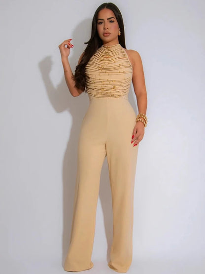 Woman wearing a beige jumpsuit with a textured top on a white background