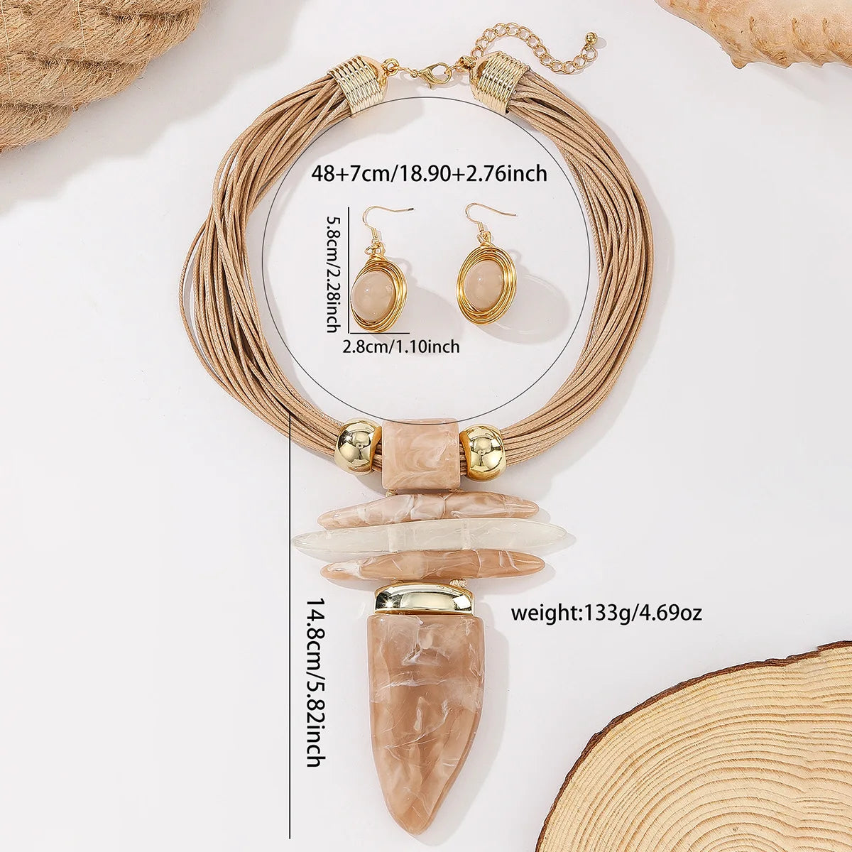 Jewelry set with necklace and earrings on a white surface with measurements displayed.