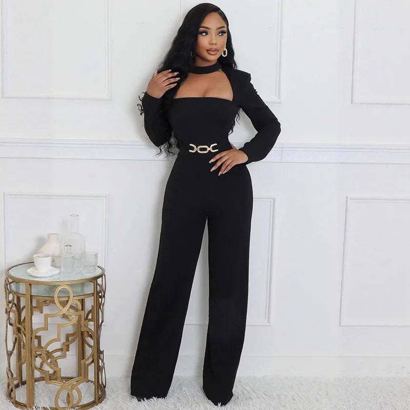 Woman in a black outfit posing in a stylish room with a decorative side table.