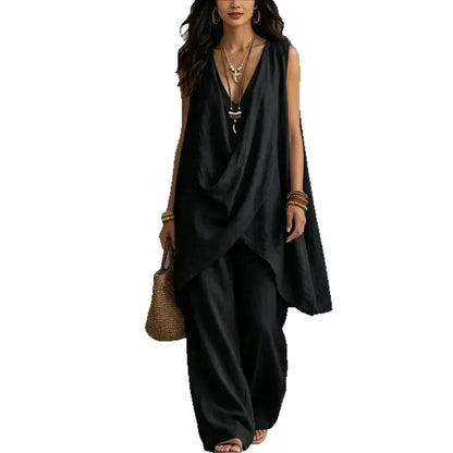Woman wearing a black sleeveless co-ord set with a deep neckline on a white background