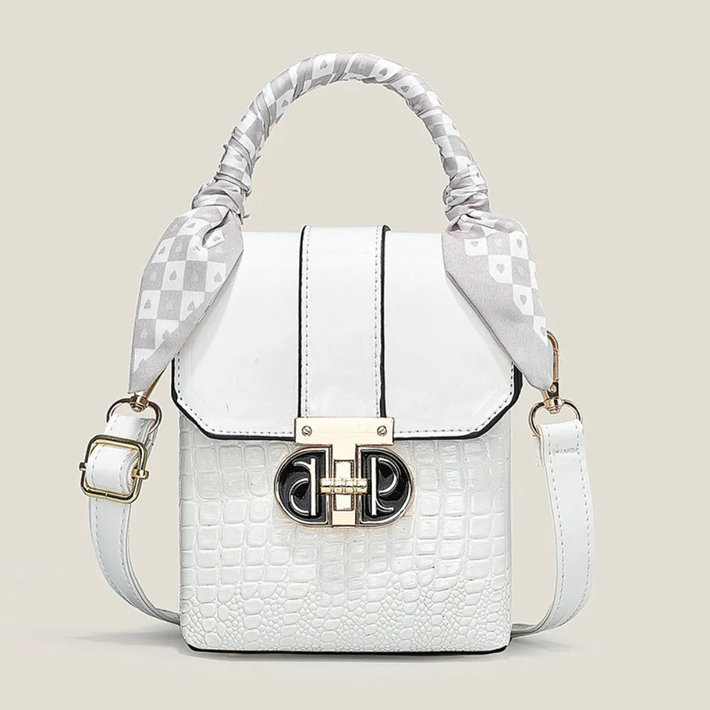 White handbag with decorative strap on a light beige background