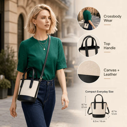 A woman wearing a green top and jeans carries a small crossbody bag with a cream canvas body and black leather trim and handles, shown on a city street. On the right are feature callouts: crossbody wear, top handle, canvas + leather detail, and compact everyday size with measurements.