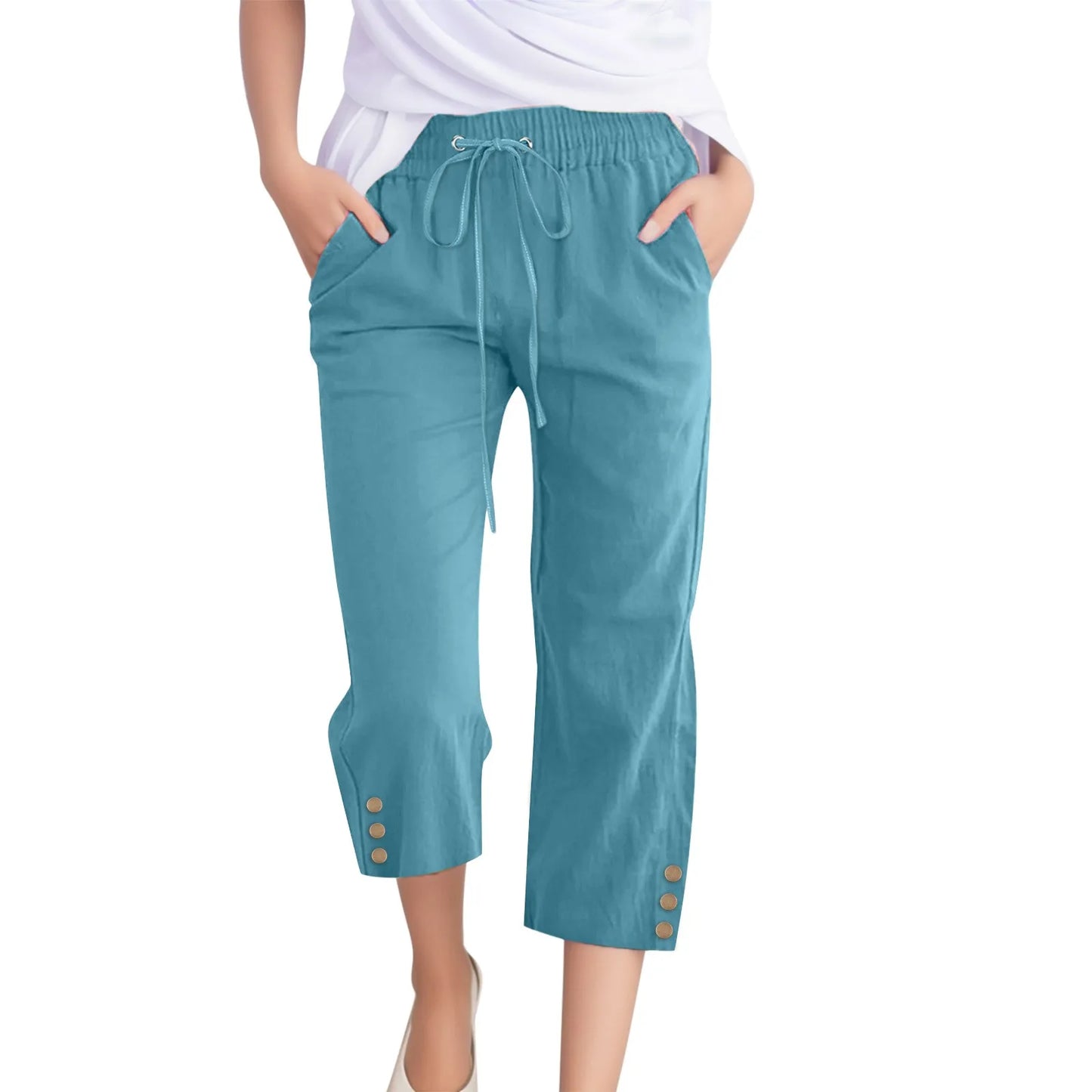 Teal capri pants with buttons on a white background