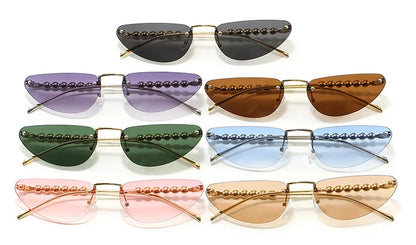 Set of cat-eye sunglasses with colorful lenses and gold frames on a white background