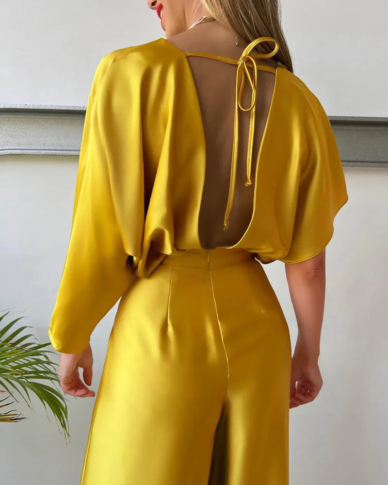 Yellow wide-leg jumpsuit styled for a formal event