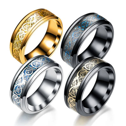 Four metallic rings with intricate designs on a white background
