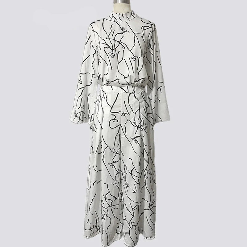 White dress with black abstract patterns on a mannequin against a white background, branded 'Versyou'.