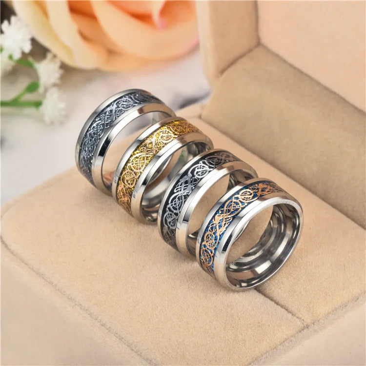 Three silver rings with intricate patterns on a beige surface