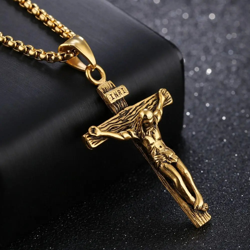 Gold crucifix pendant on a black background