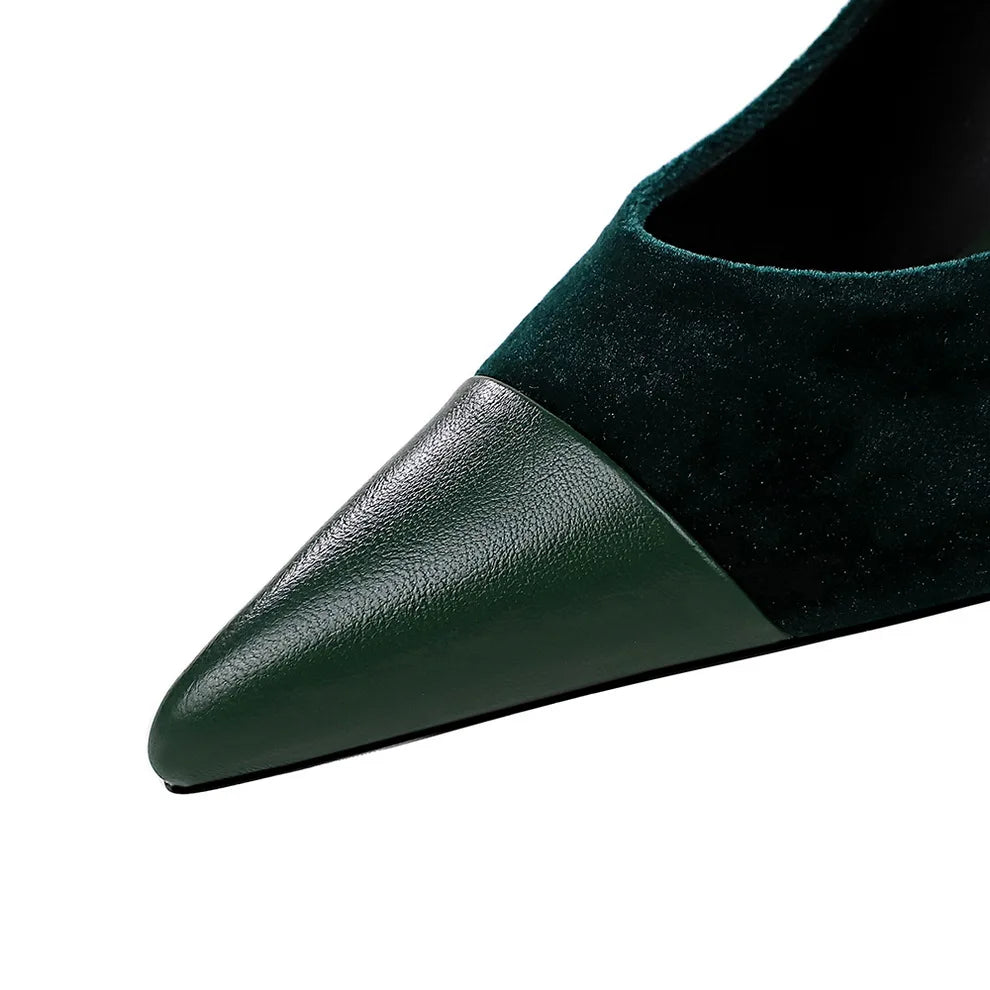 Close-up of a green shoe with a pointed toe on a white background