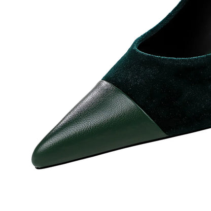 Close-up of a green shoe with a pointed toe on a white background