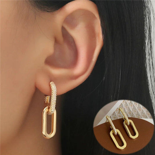 Gold hoop earrings worn by a person with a close-up inset showing the earrings.
