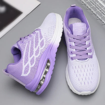 A pair of women's athletic sneakers in light purple and white, featuring a breathable knit upper, lace-up closure, and visible air cushioning in the sole, displayed on a gray surface.