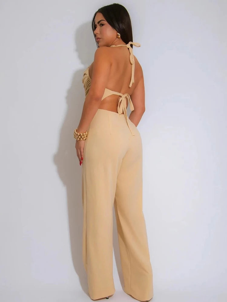 Woman wearing a beige jumpsuit with a white background