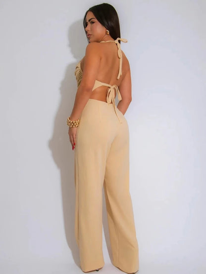 Woman wearing a beige jumpsuit with a white background