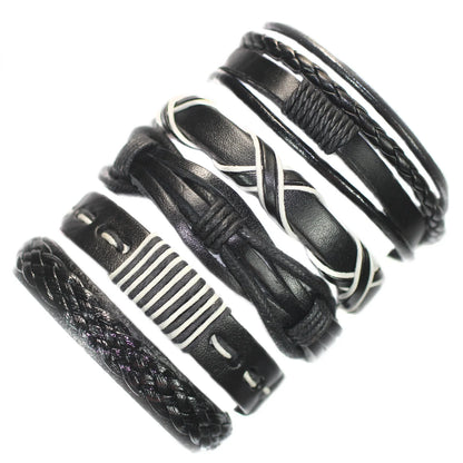 Set of black leather bracelets with various designs on a white background