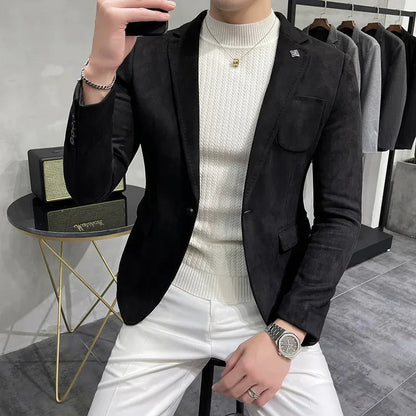 Person wearing a black blazer over a white sweater and pants in a clothing store.