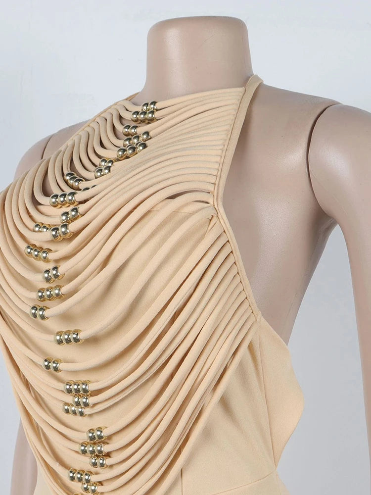 Beige dress with embellishments on a mannequin against a white background