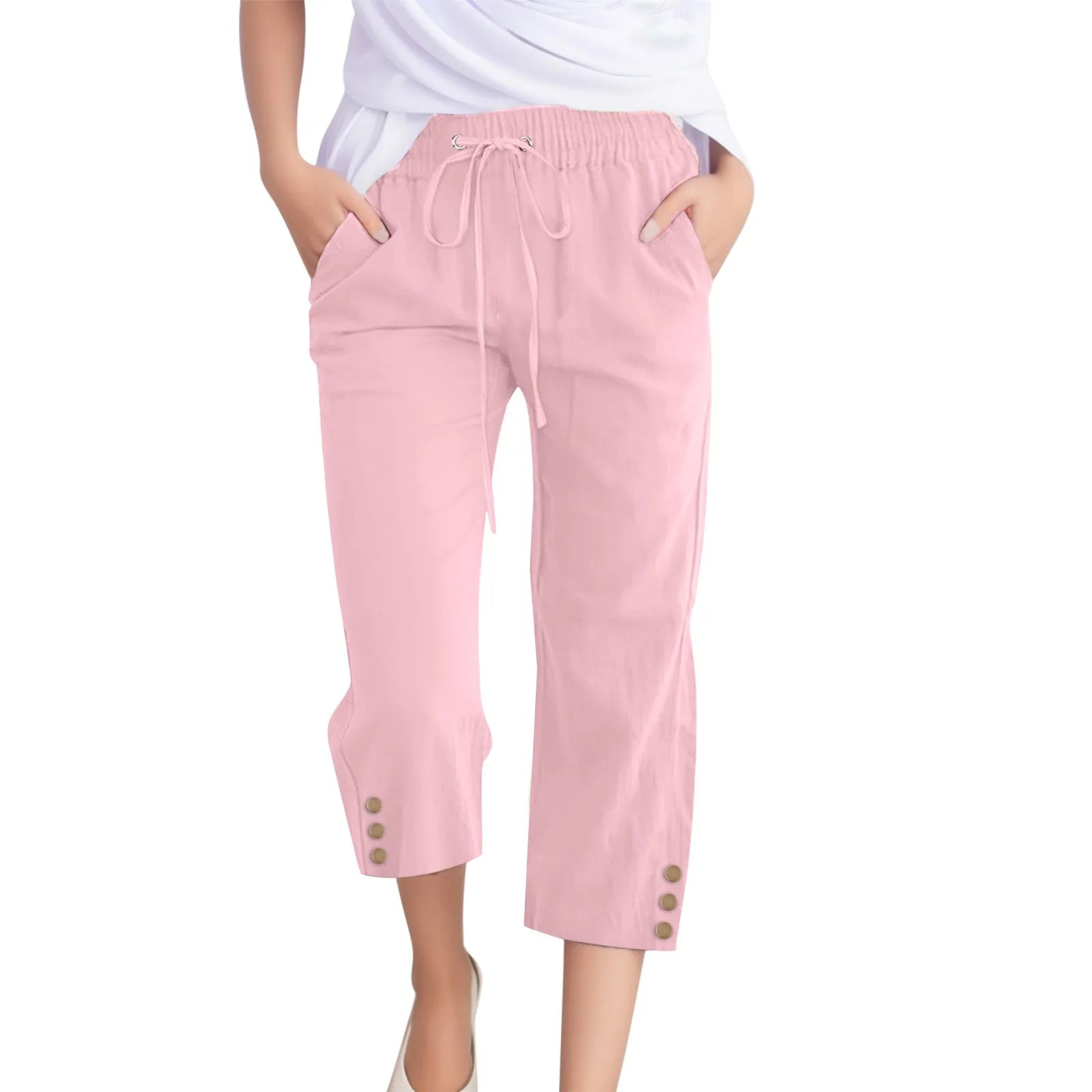 Pink capri pants with drawstring waist and button details on a white background