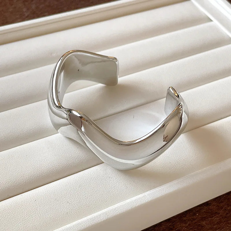 Silver bracelet on a white jewelry display