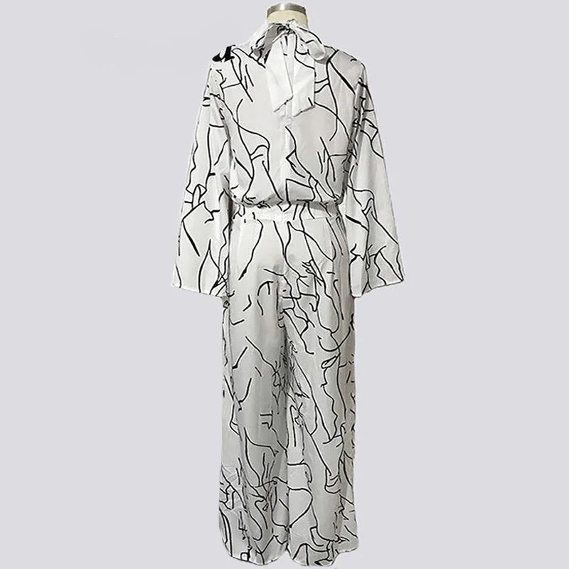 White dress with black abstract patterns on a light gray background, branded 'Veryou'.