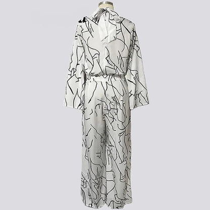 White dress with black abstract patterns on a light gray background, branded 'Veryou'.