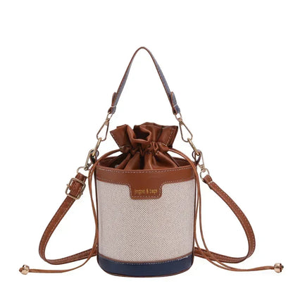 Drawstring bag with brown leather accents on a white background