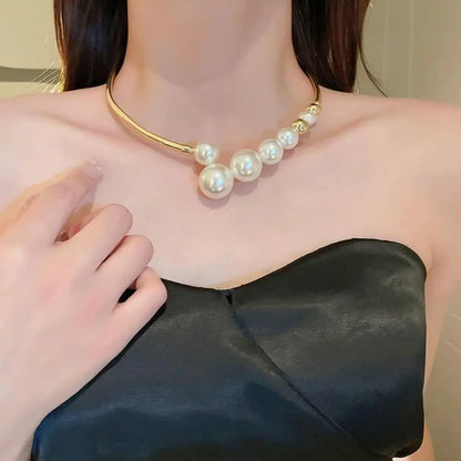 Pearl necklace being worn by a person with a blurred background