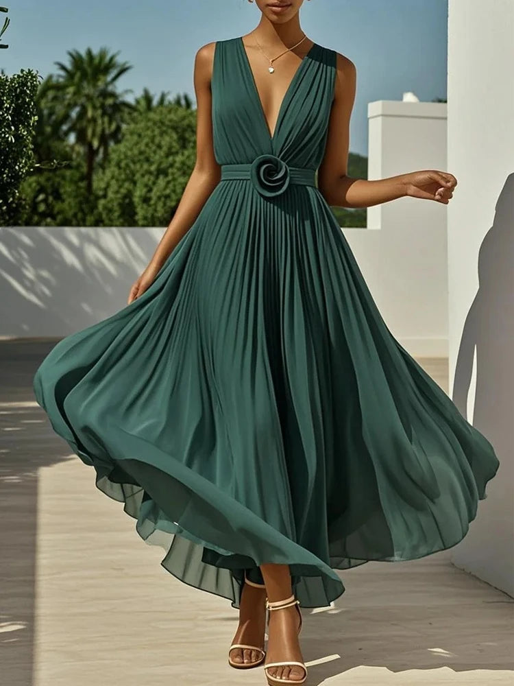 Green dress with a floral detail being modeled outdoors.