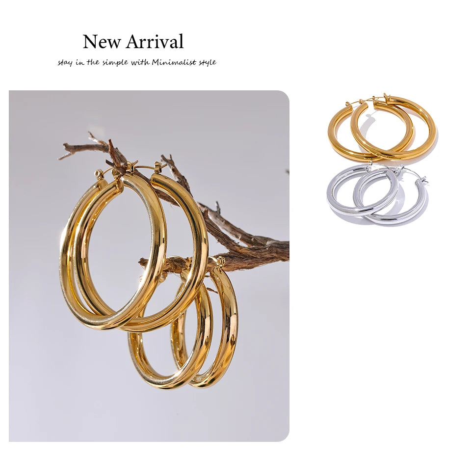 Gold hoop earrings on a branch with 'New Arrival' text.
