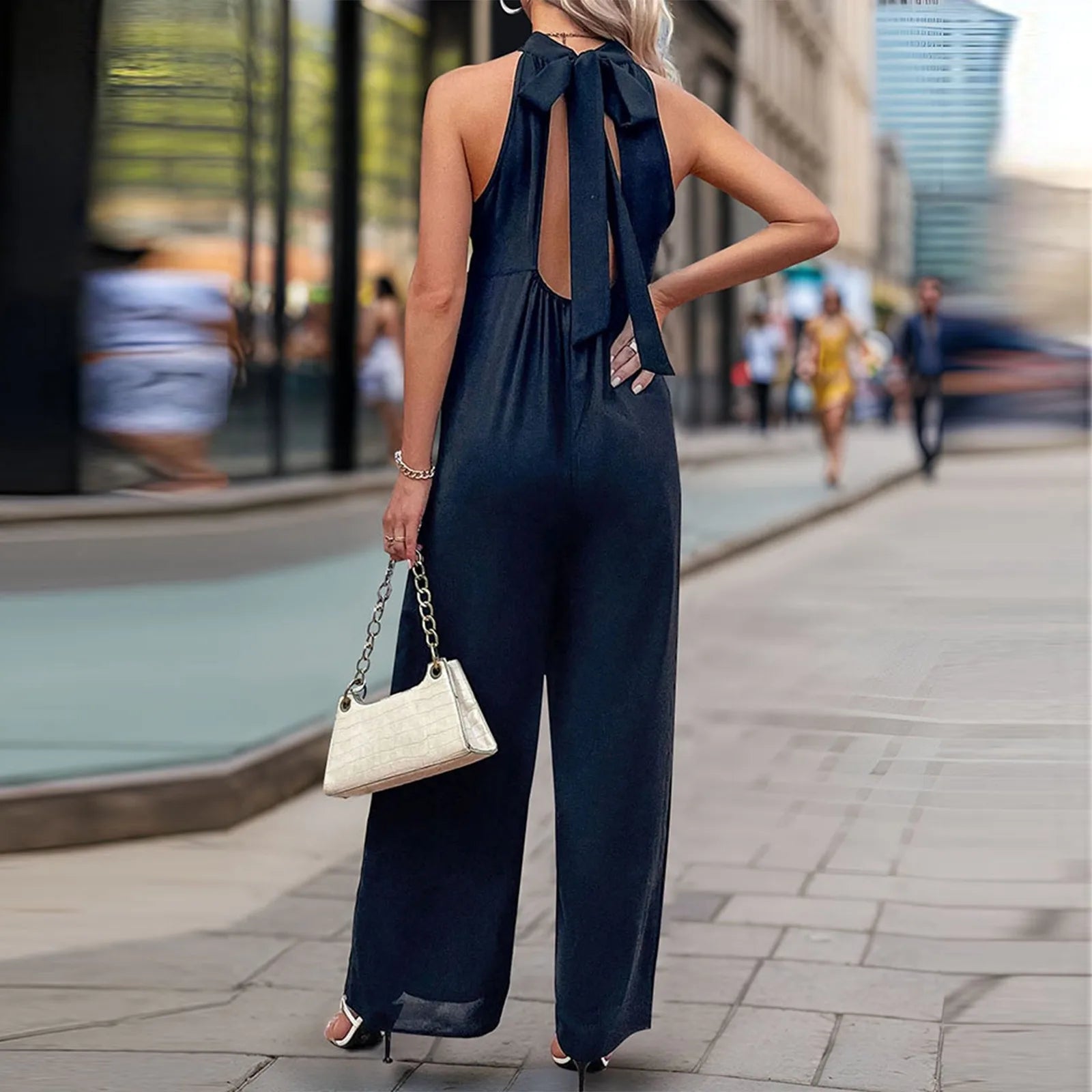 Back view of halter-neck wide-leg jumpsuit with bow-tie detail.