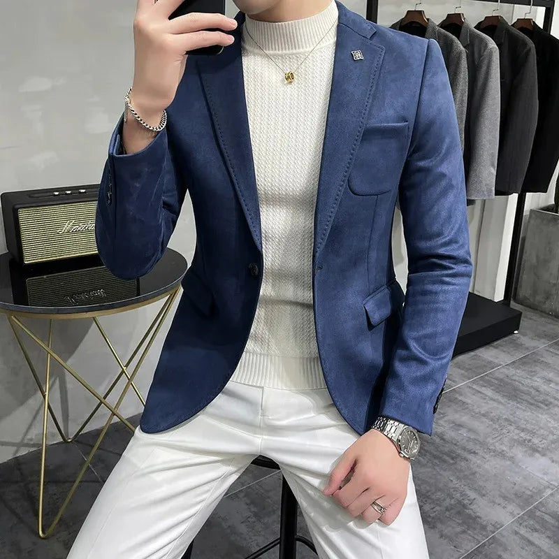 Person wearing a blue blazer over a white sweater and pants in a clothing store.