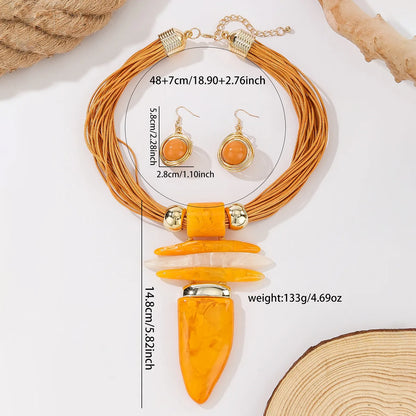 Jewelry set with necklace, earrings, and pendant on a light background