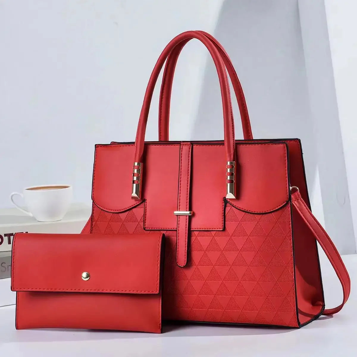 Red handbag with a matching wallet on a light gray background