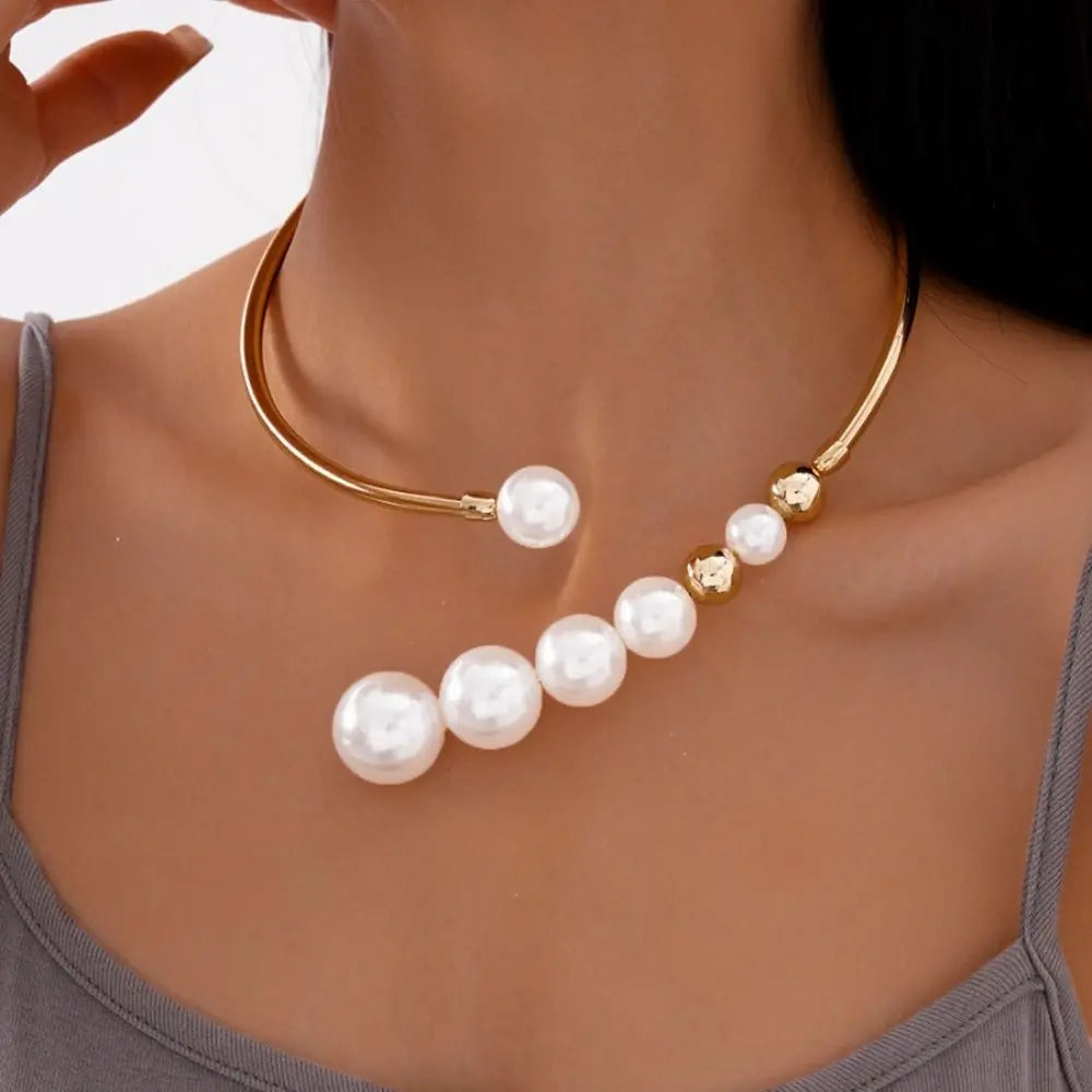 Gold necklace with pearls worn by a person
