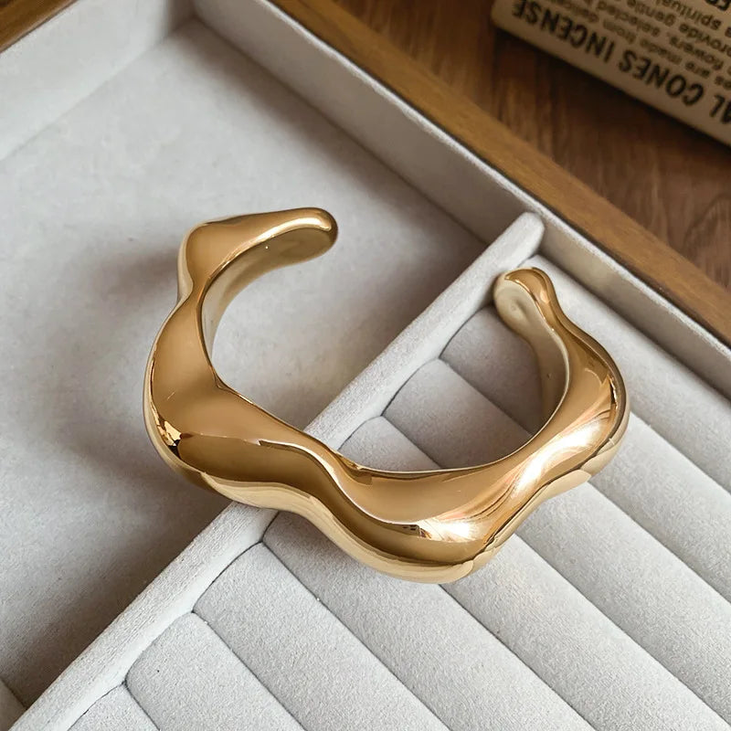 Gold bracelet on a soft, textured surface