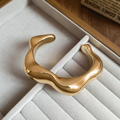 Gold bracelet on a soft, textured surface