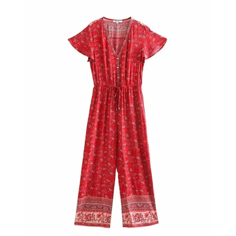A red short-sleeve jumpsuit with a small white floral print, a V-neckline, and a drawstring waist, shown against a plain white background.