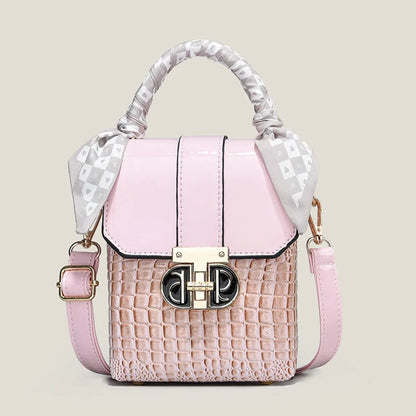 Pink handbag with a textured pattern and decorative handle on a light beige background