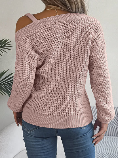 Pink knitted sweater worn by a person with a neutral background