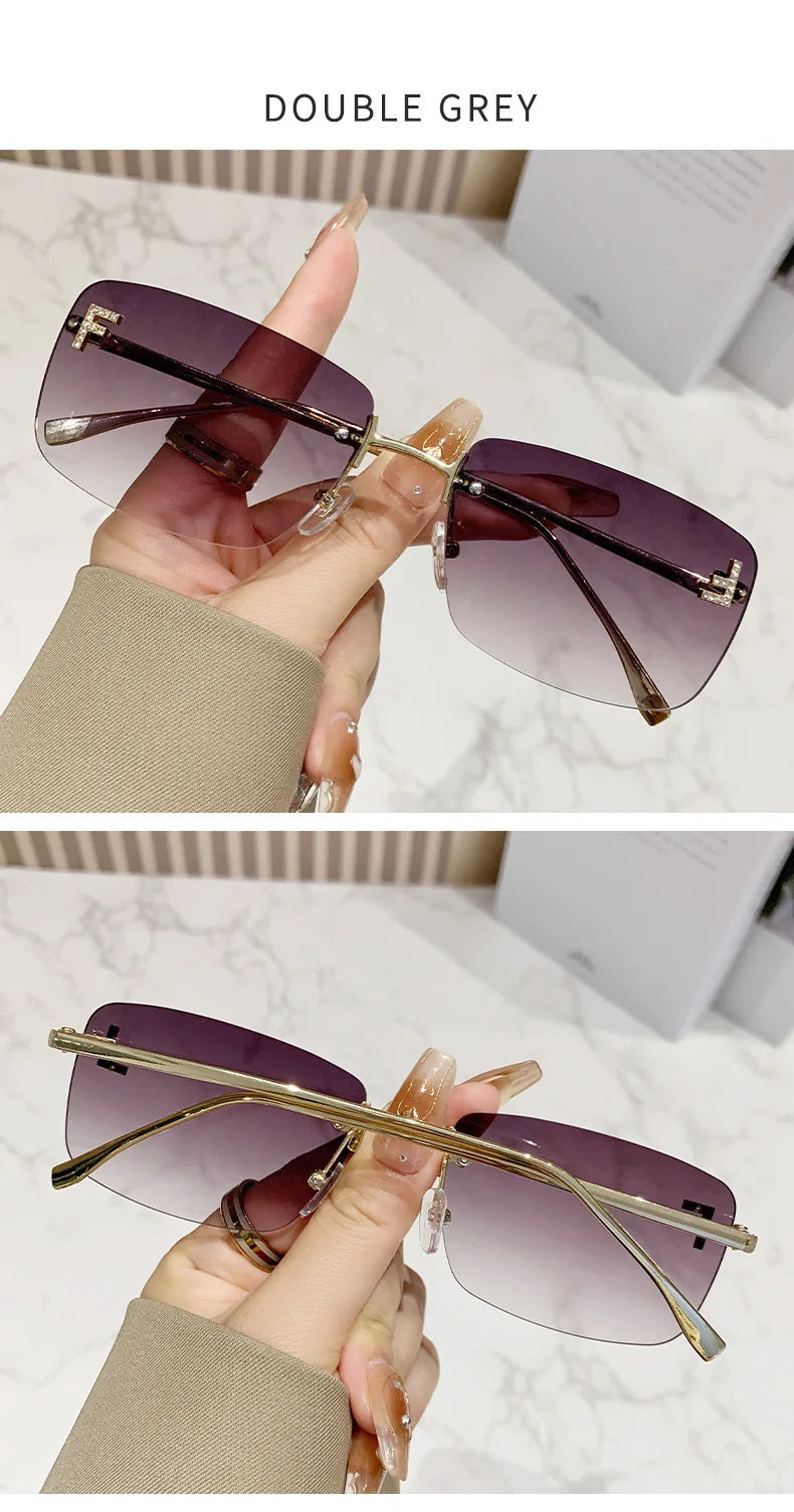 Sunglasses with purple lenses and gold frames held by a hand on a marble surface.