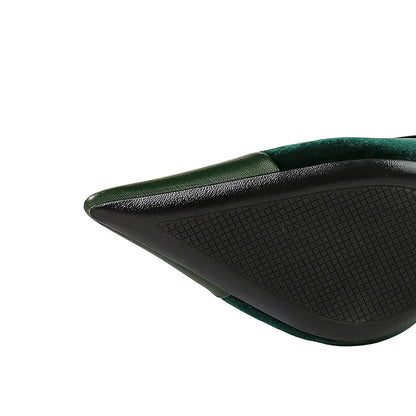 Close-up of a green and black shoe with textured sole on a white background