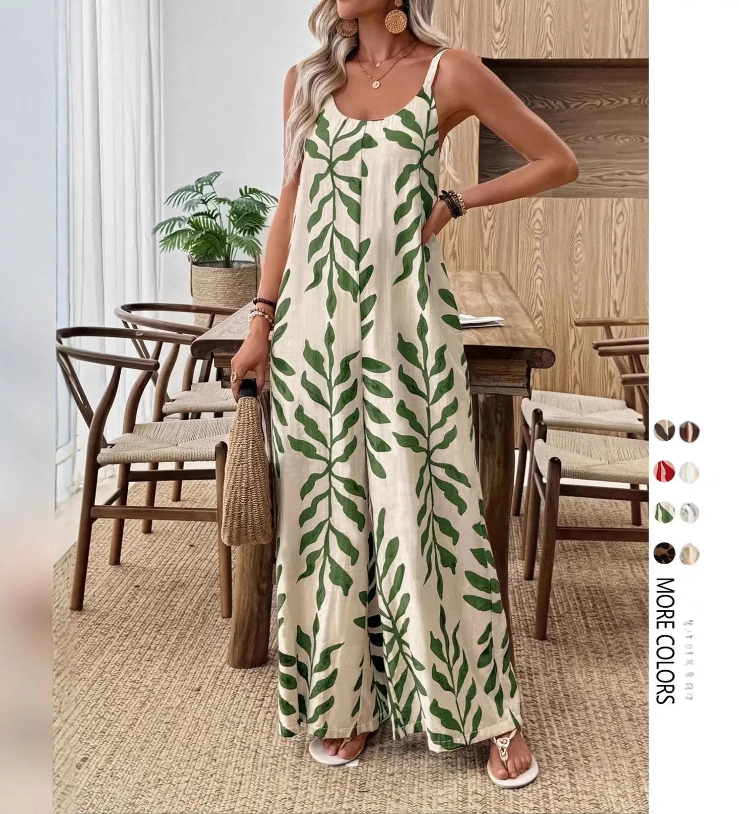Woman wearing a green leaf-patterned jumpsuit in a dining room setting.