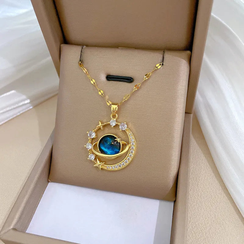 Gold necklace with a blue gemstone pendant in an open box