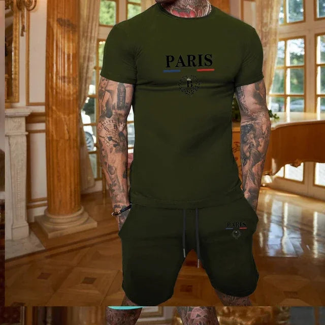 Person wearing a green 'PARIS' t-shirt and shorts in an indoor setting.